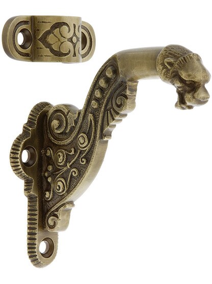 Lion Head Handrail Bracket in Antique Brass.